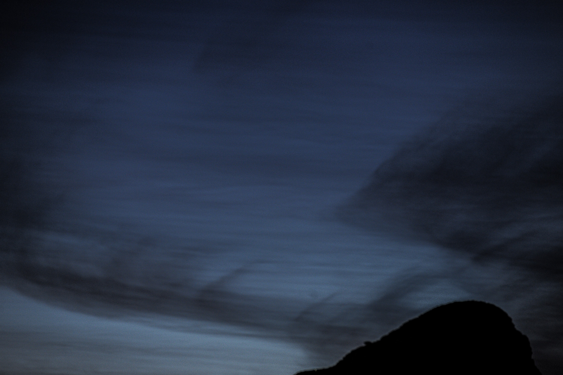 A hill photographed against the night sky. 