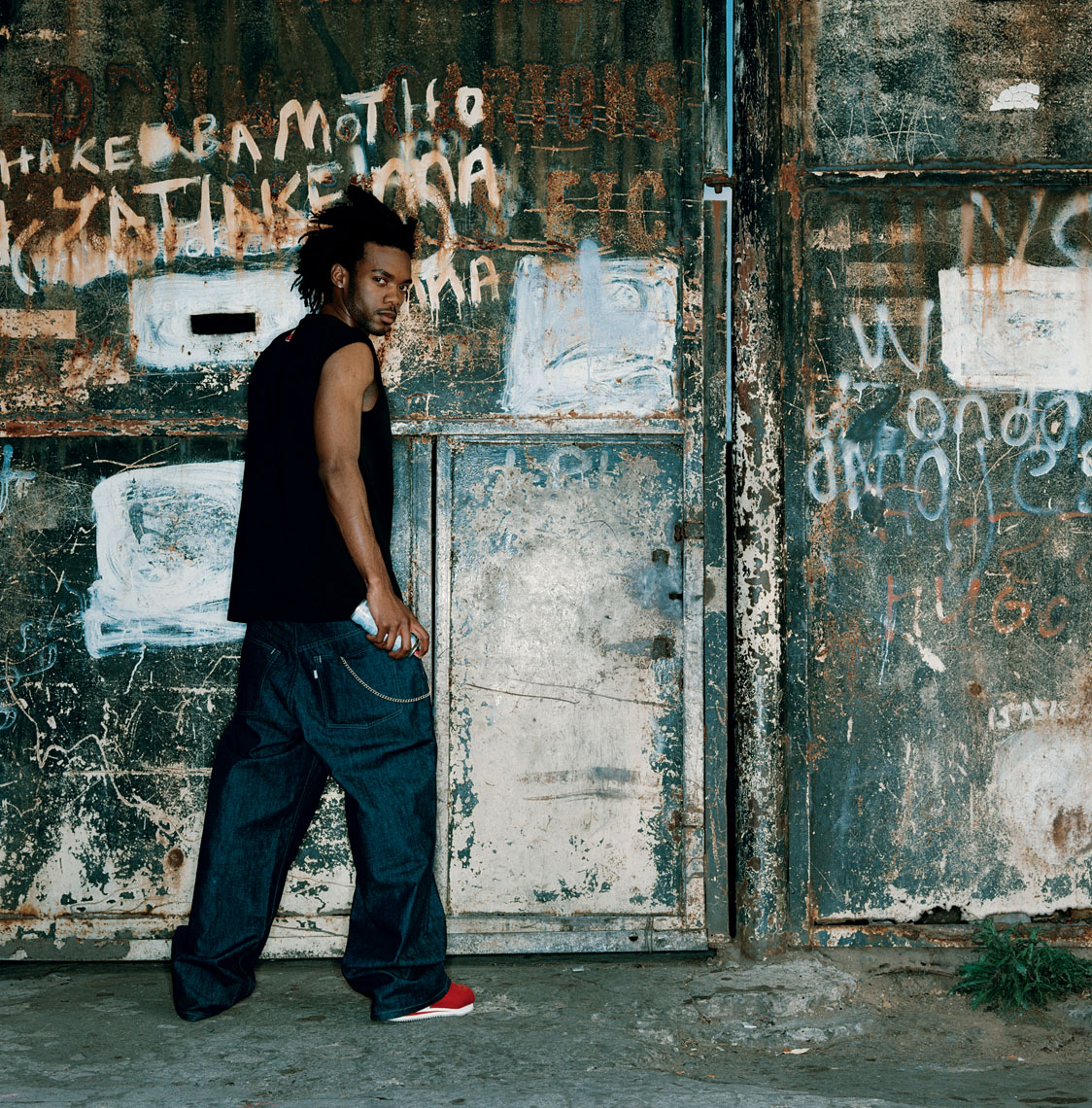 A  portrait of a hip graffiti artist, wearing Levi jeans. 