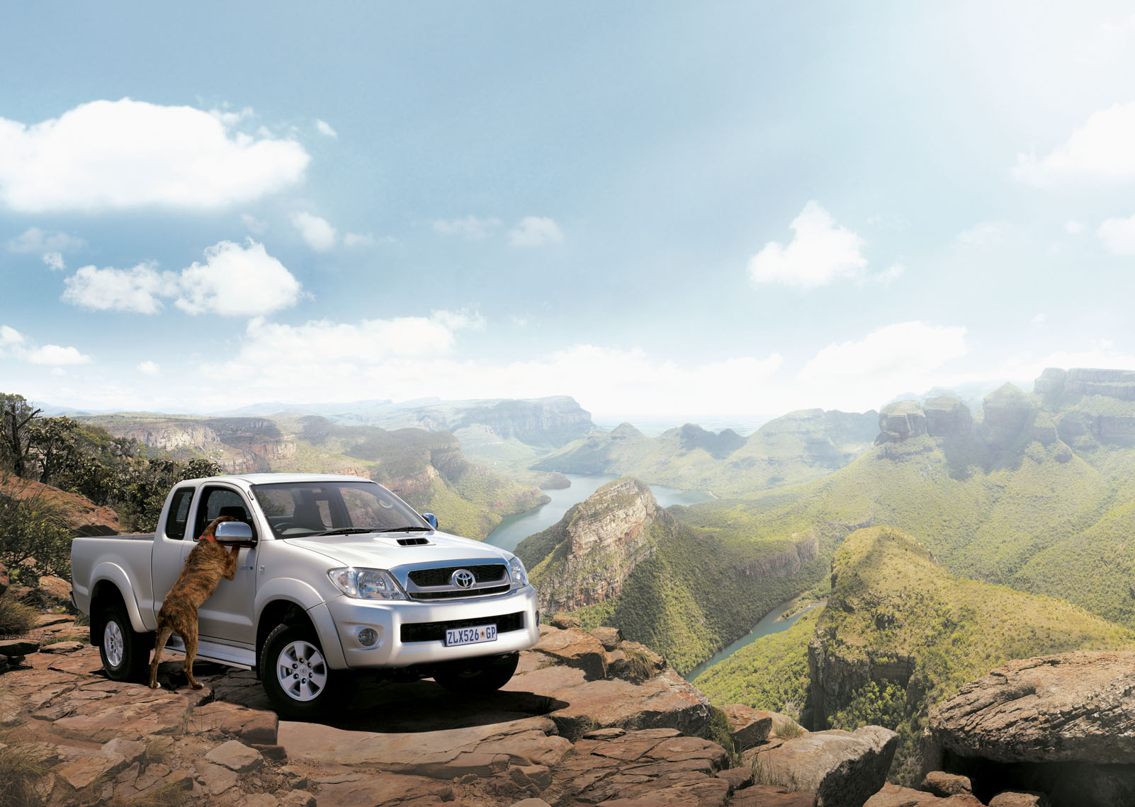 Silver Toyota Hilux pick-up parked in a majestic mountains canyon. 