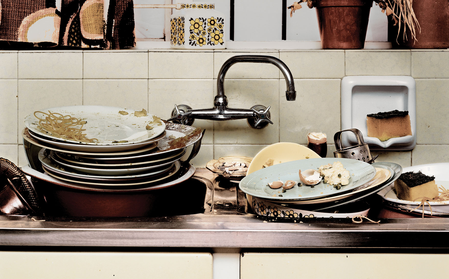 A kitchen sink loaded with dirty dishes. 
