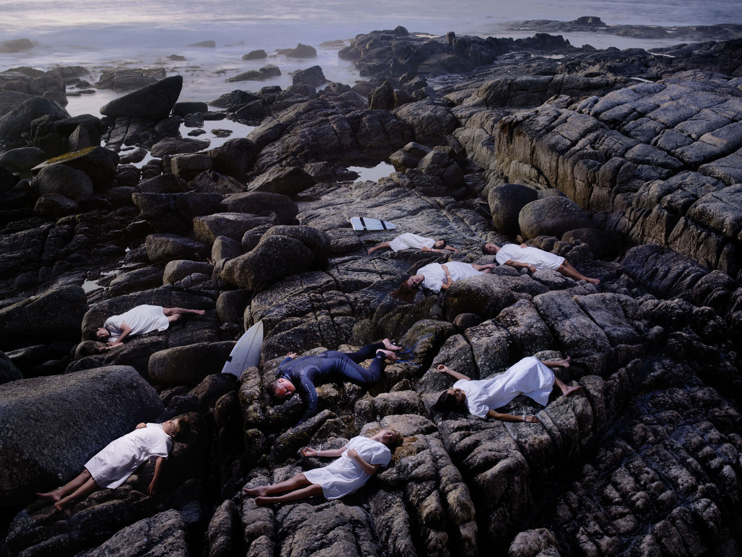 7 bodies lying on rocks representing the failure of one person to donate their organs.