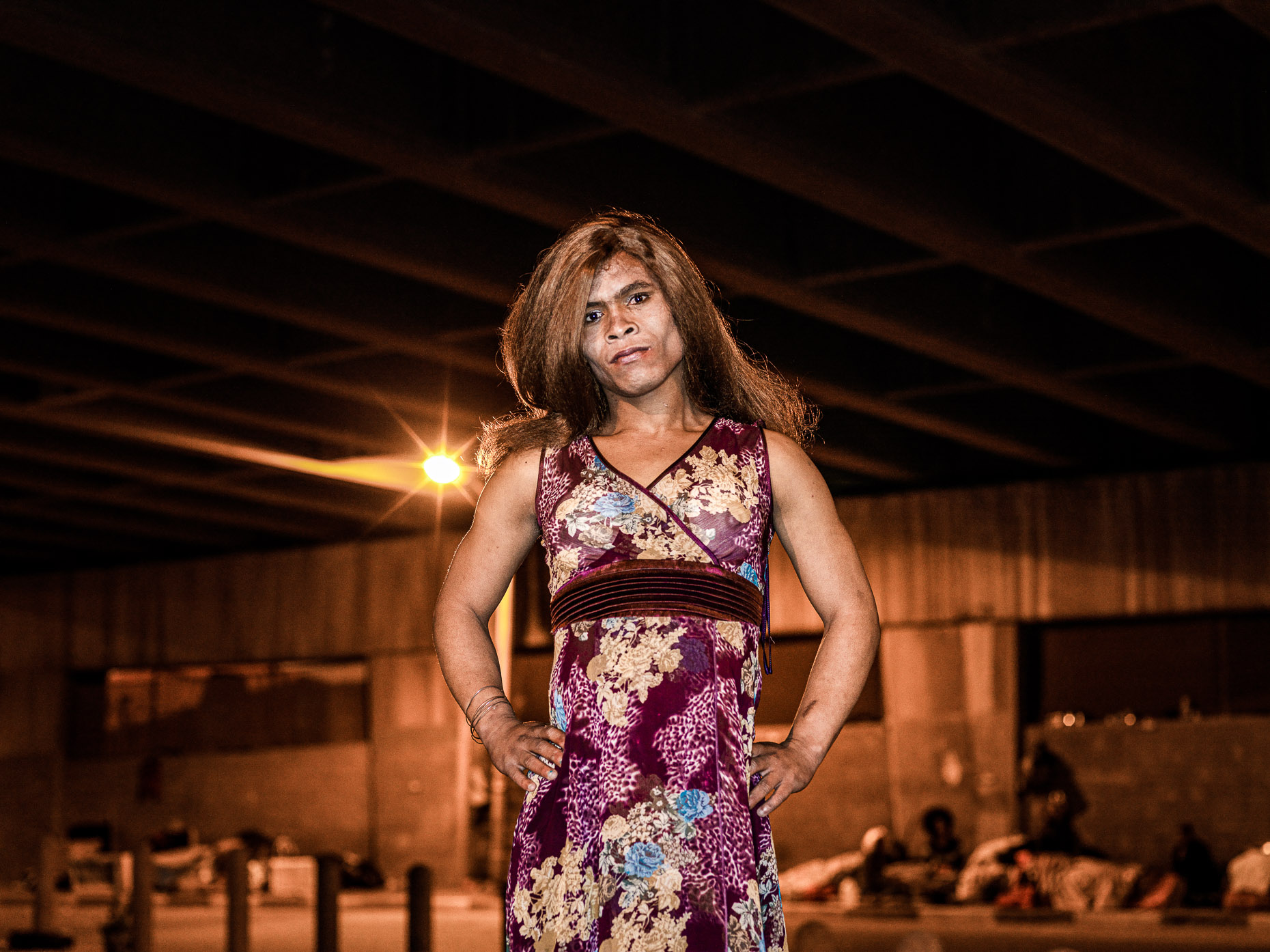 Trans woman with  a long  auburn wig  posing to have her portrait taken.