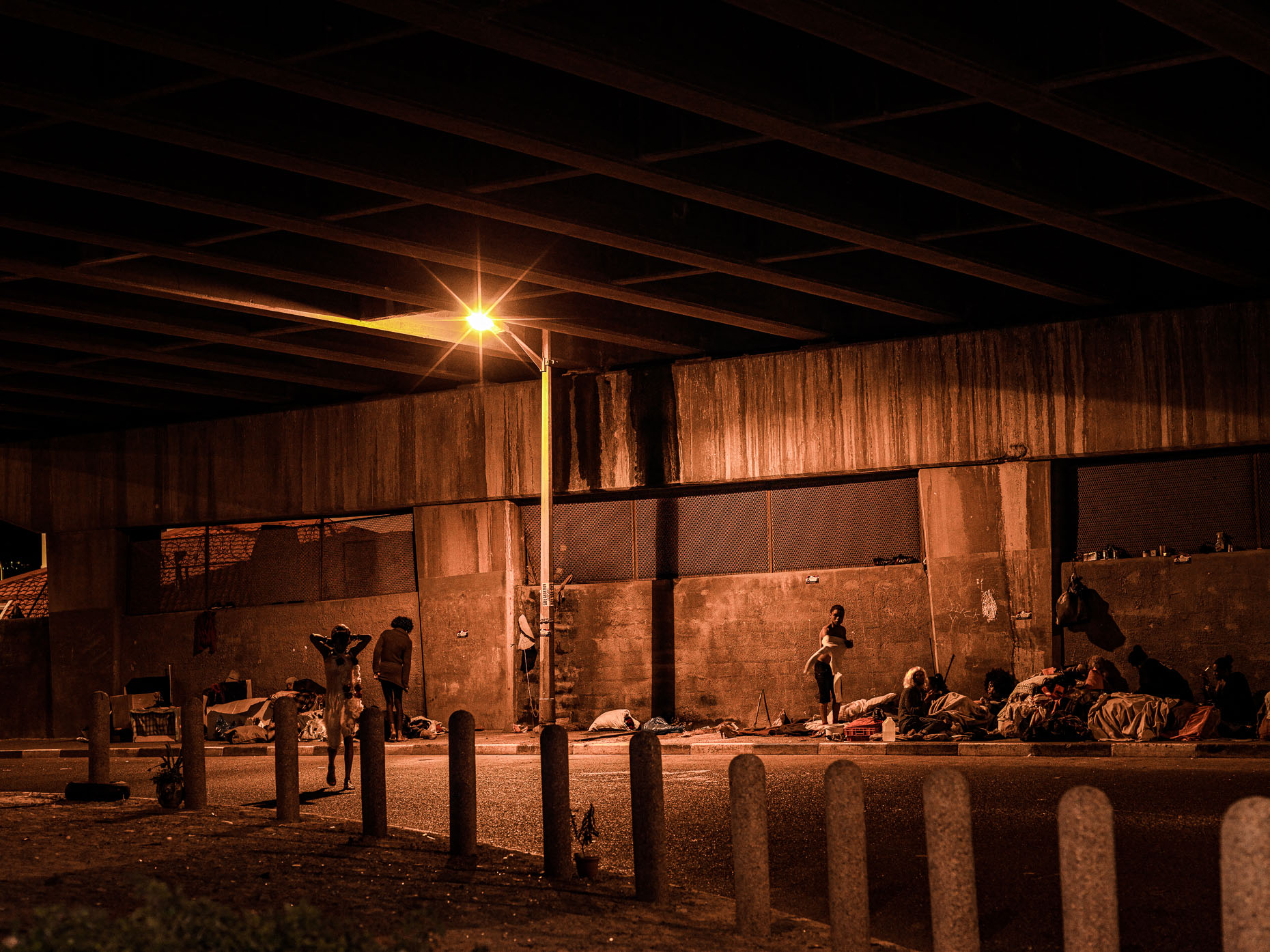 Under the Woodstock Bridge, downtown Cape Town, at night, and home to a transgender community.