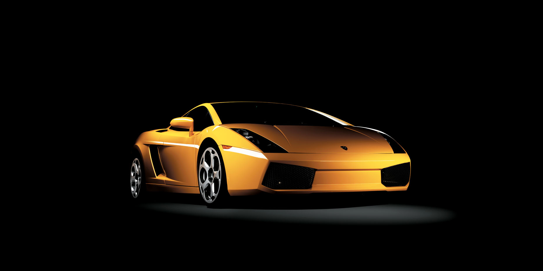 A front shot of a yellow Lamborgini photographed in a studio on a black background.