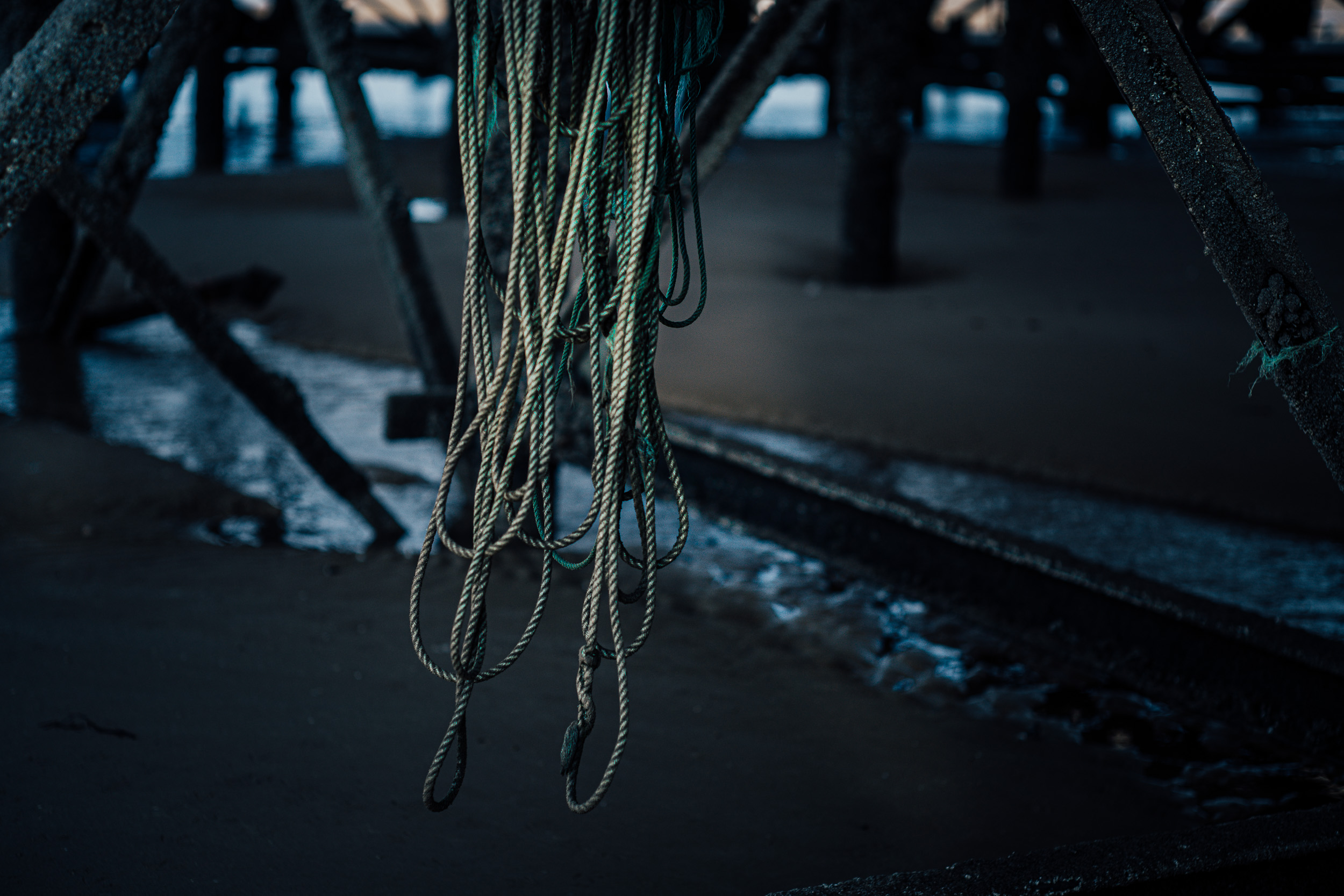 Rope dangling from a steel rusted railing on the Blackpool pier. 